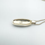 Back of silver pendant stamped 925 on concave oval setting