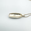 Back of silver pendant stamped 925 on concave oval setting