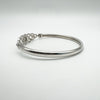 Right angle showing the bangle’s sleek form and hinge detail