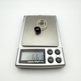 Sterling silver amethyst ring shown weighing 6.6g on digital scale
