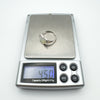Sterling silver heart-shaped mother of pearl ring displayed on scale reading 4.5g