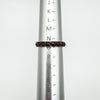 Vintage garnet eternity ring on sizer showing UK ring size N to O