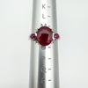 Ruby trilogy ring shown on a ring mandrel, indicating UK ring size N