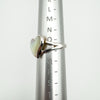 White mother of pearl heart ring shown on ring sizer at UK size N to O