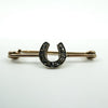 Close-up of antique 9ct gold horseshoe bar brooch with rose cut diamonds set in silver