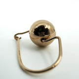 Close-up of 9ct rose gold ball earring showing polished bead and curved hook wire