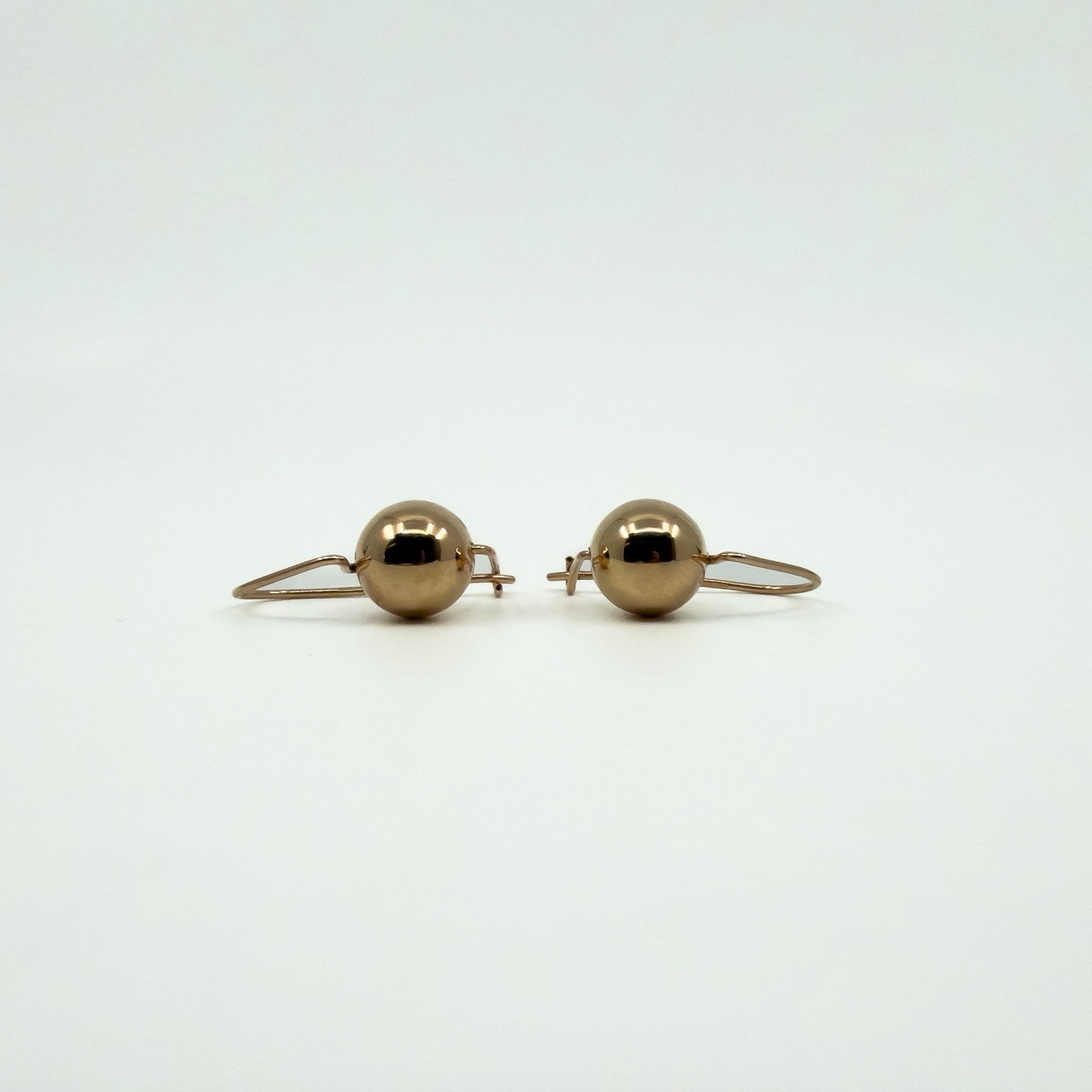 Front view of 9ct rose gold ball drop earrings with hook wire fittings for pierced ears