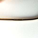 Close-up of 9ct rose gold earring wire stamped 375 with hallmark details visible