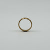 Upright view of vintage 18ct rose gold faceted band ring showing the full round profile.