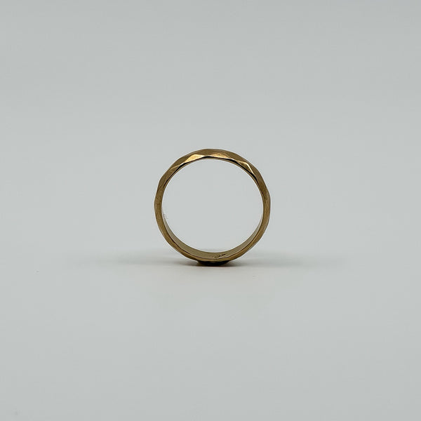 Upright view of vintage 18ct rose gold faceted band ring showing the full round profile.