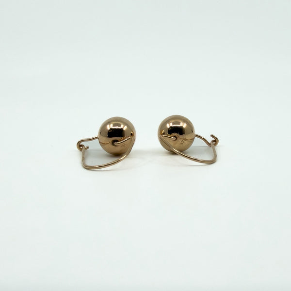 Reverse view of 9ct rose gold ball hook drop earrings showing curved wire fittings