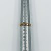 Vintage 18ct rose gold faceted band ring shown on a ring mandrel at UK Size M.