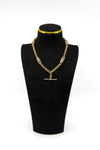 Antique 9ct rose gold Albert chain on a black display bust, showing the T bar and fancy link design