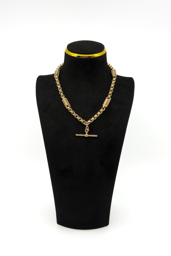 Antique 9ct rose gold Albert chain on a black display bust, showing the T bar and fancy link design