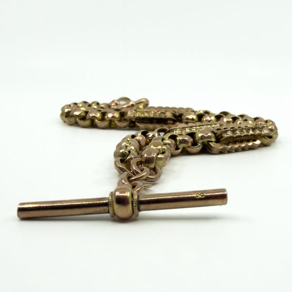 Close up of the T bar on an antique 9ct rose gold Albert chain, showing the stamped mark