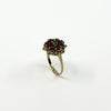 Angled view of vintage 18ct gold ruby emerald and diamond cluster ring with high-set gemstone head