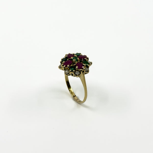 Angled view of vintage 18ct gold ruby emerald and diamond cluster ring with high-set gemstone head