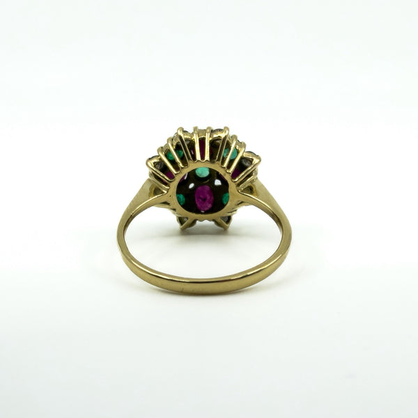Close reverse detail of 18ct gold cluster ring showing rubies, emeralds and diamonds in claw settings