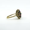 Side profile of 18ct gold ruby emerald and diamond cluster ring with open gallery setting