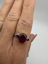 Sterling silver ruby trilogy ring worn on finger for scale and fit view