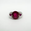 Front view of sterling silver trilogy ring set with three rubies and four diamonds