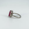 Angled view of ruby and diamond ring with decorative setting