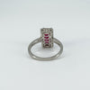 Underside of ruby and diamond halo ring showing openwork gallery