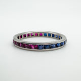 Vintage 18ct white gold eternity ring with sapphires and rubies flat on surface