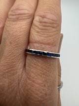 18ct white gold eternity ring worn with sapphires facing up on finger