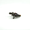Side angle of sterling silver giardinetti brooch showing setting height and pin hook fitting.