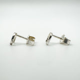 Side profile showing silver horseshoe studs and butterfly backs