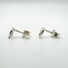 Side profile showing silver horseshoe studs and butterfly backs
