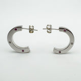 Side view showing curved chunky shape and asymmetric pink sapphire and diamond settings