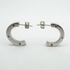 Side view showing curved chunky shape and asymmetric pink sapphire and diamond settings
