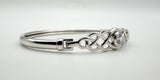 Side profile showing bangle curvature and hook clasp connection
