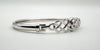 Side profile showing bangle curvature and hook clasp connection