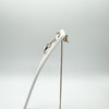 Side angle showing necklace and earrings set on white display stand