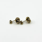 Side profile of vintage 9ct gold knot stud earrings in textured knot design