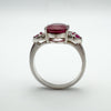 Side view of ruby trilogy ring showing claw setting and band structure