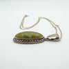 Side view of green Connemara pendant showing marcasite border and curved silver setting