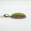 Detailed side view showing domed green Connemara stone and marcasite setting