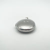 Side view of oval locket showing diamond starburst on front