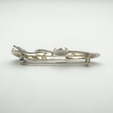 Side profile of vintage sterling silver Celtic brooch with floral design
