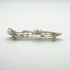 Side profile of vintage sterling silver Celtic brooch with floral design