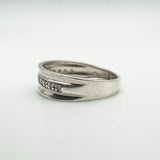 Side angle showing flush diamond setting and smooth concave design