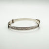 Side view of vintage baby bangle showing engraved silver design