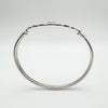 Side profile showing the depth of the CZ bezel setting above the knotwork