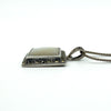 Side view of the sterling silver mother of pearl pendant, showing depth of the setting and marcasite edge.