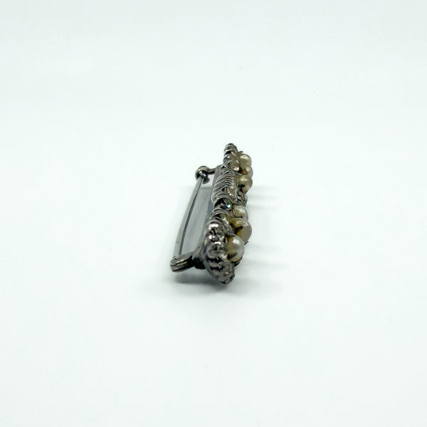 Side profile of antique sterling silver bar brooch showing the pin and clasp height.