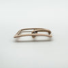 Side profile of antique rose gold buckle charm showing bar and pin shape